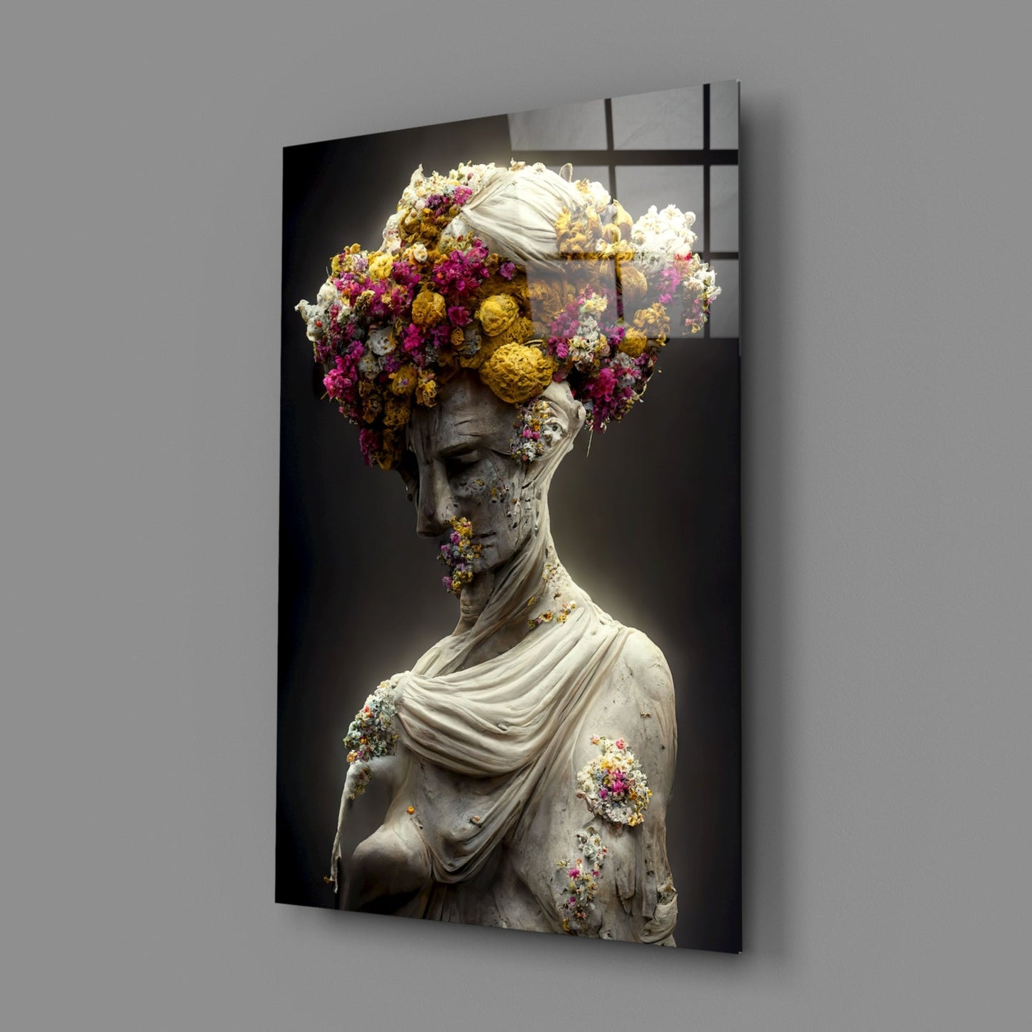 Glass wall art panel displaying a classical stone bust adorned with vibrant magenta, yellow, and white flowers against a dark background.