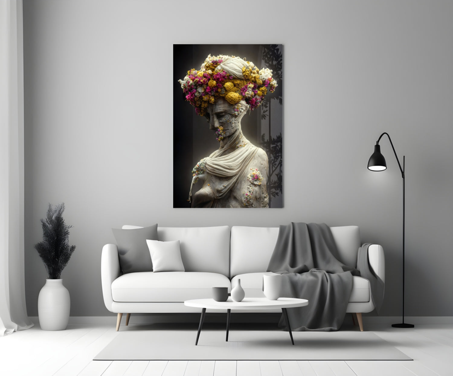 Classical stone bust adorned with vibrant yellow, pink, and white flowers displayed above a white sofa in a modern living room.