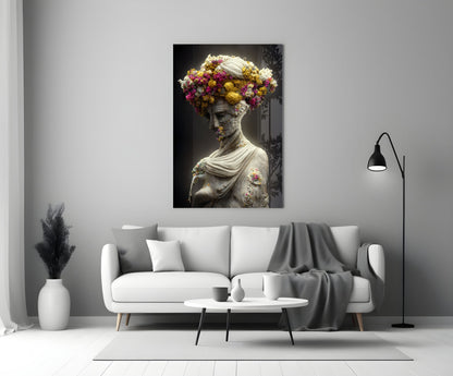 Classical stone bust adorned with vibrant yellow, pink, and white flowers displayed above a white sofa in a modern living room.