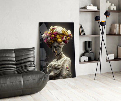 Classical stone bust with vibrant pink and yellow flowers adorning head and shoulders, displayed in modern living room setting.