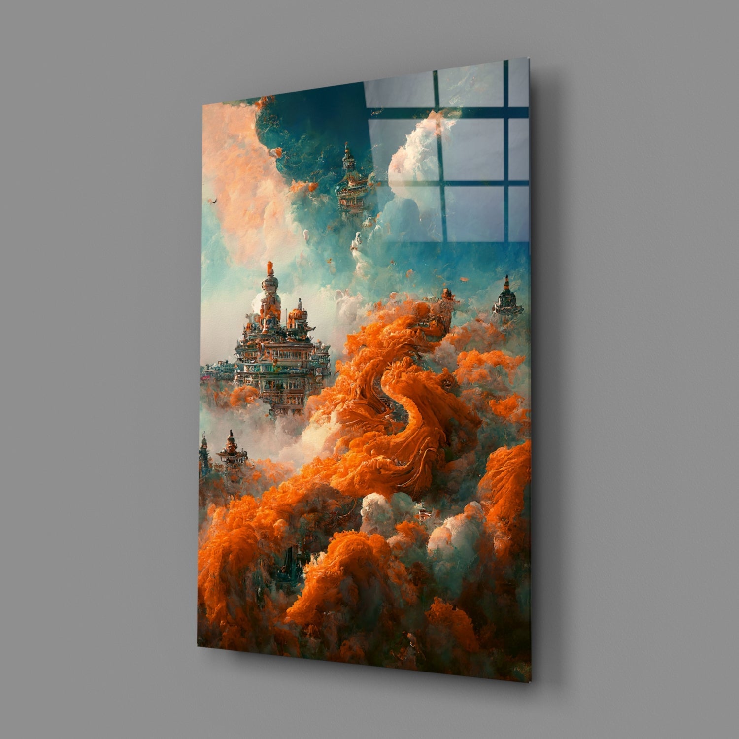 Angled view of glass art panel displaying ornate castles emerging from swirling orange and white clouds against teal sky, mounted on gray wall.