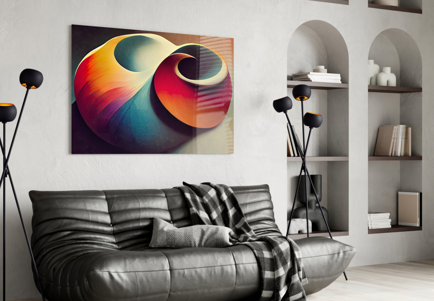 Colorful abstract shell glass art featuring gradient swirls of orange, red, blue, and yellow displayed above a black leather sofa in a modern living room.