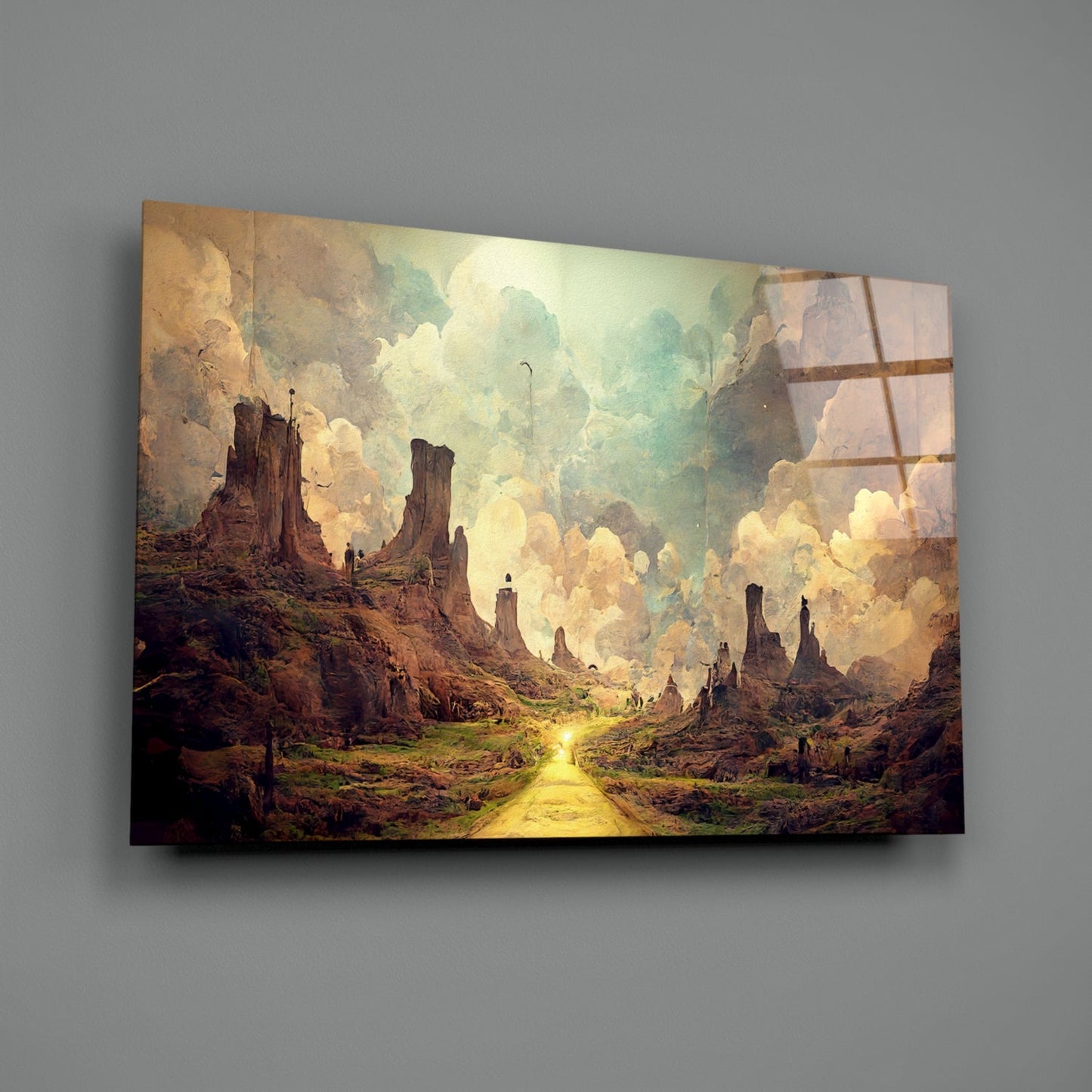 Glass art print displayed on gray wall showing a golden road through a fantasy canyon landscape with towering rock formations and luminous clouds.