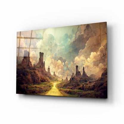 Glass art print displayed at an angle showing a fantasy landscape with towering rock formations, golden path, and luminous cloudy sky.