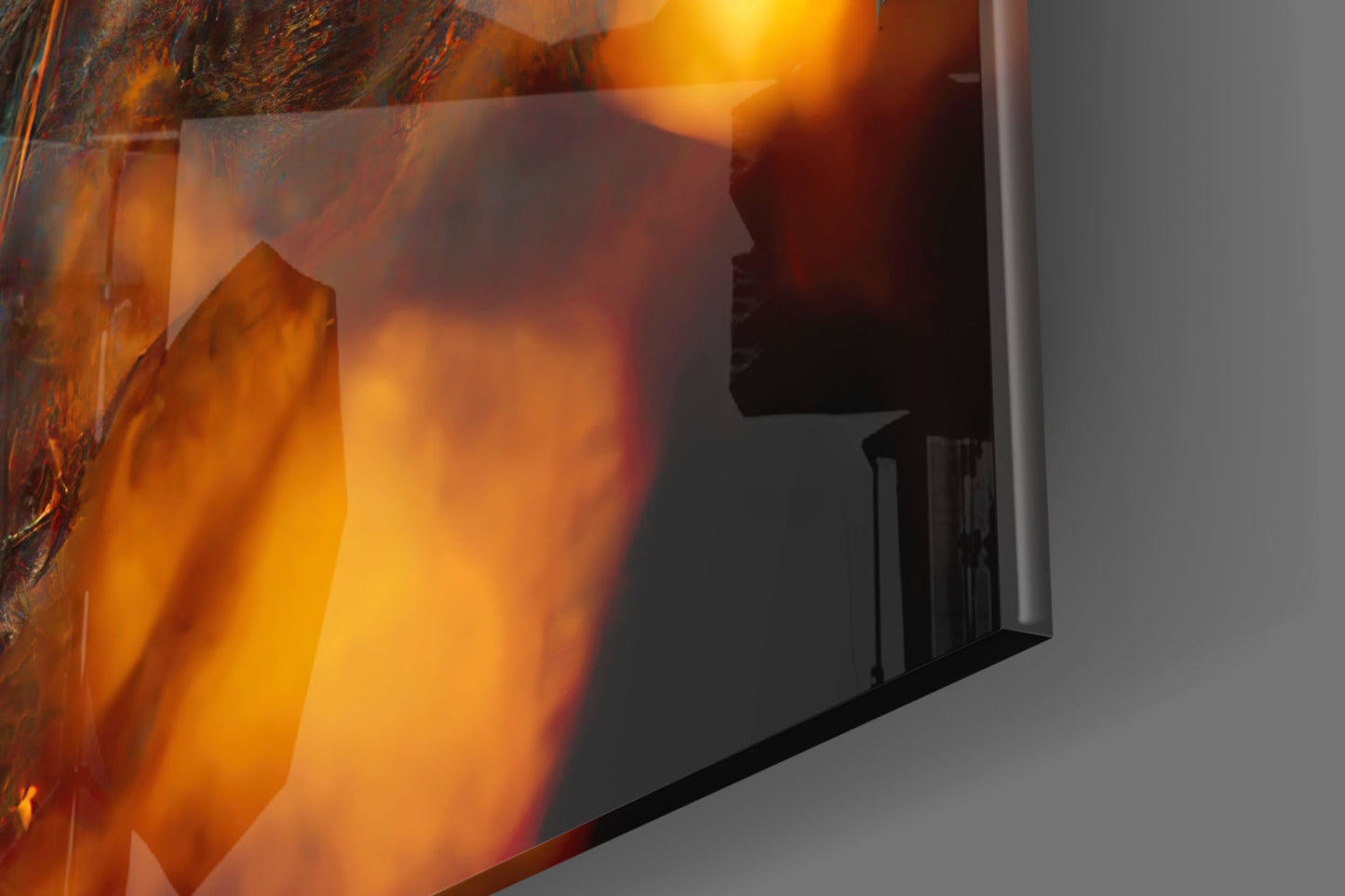 Close-up of amber and orange glass art piece with translucent layered surfaces and warm glowing light effects.