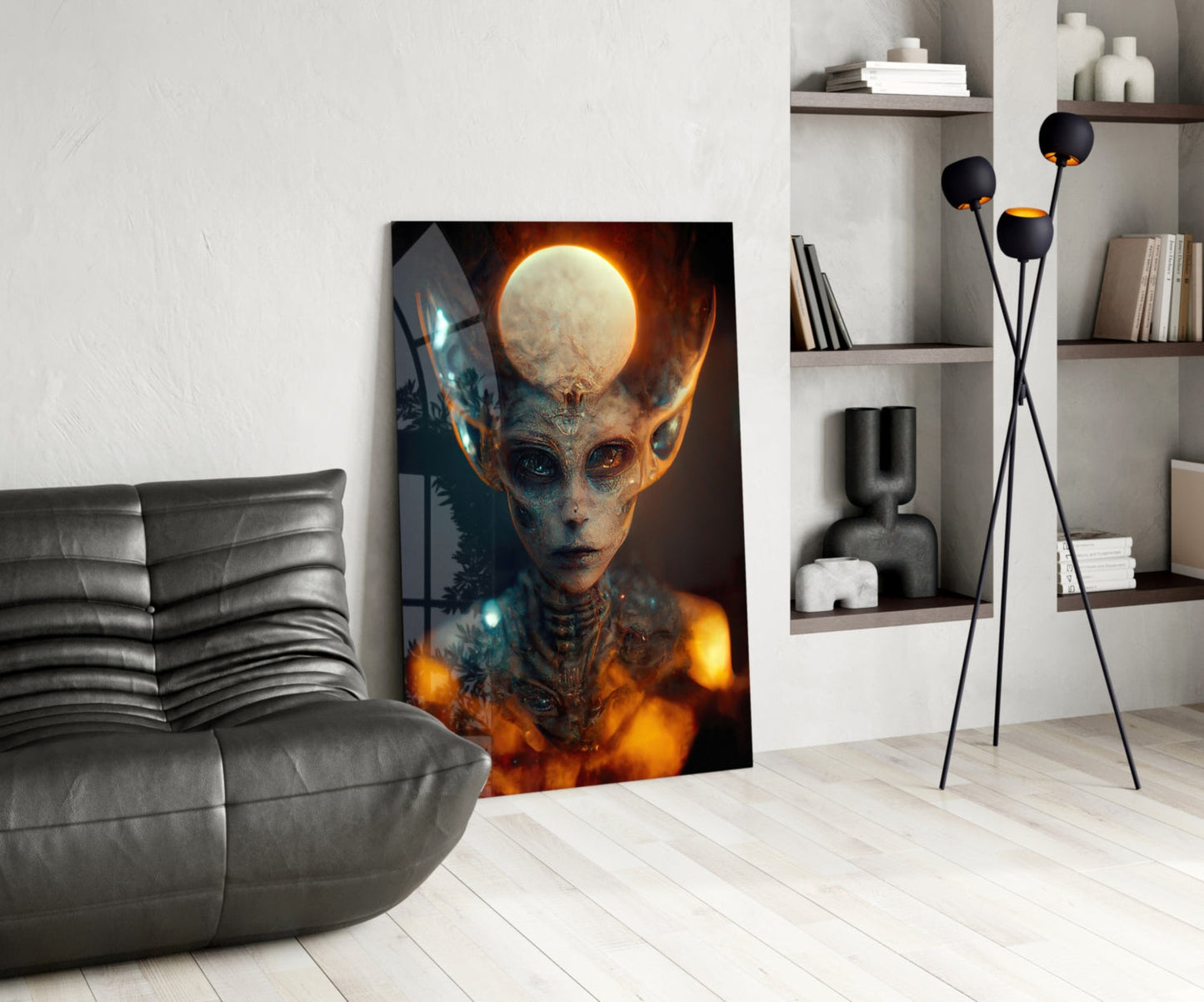 Glass art print of glowing alien figure with luminous moon head displayed in modern living room setting with gray sofa and shelving.
