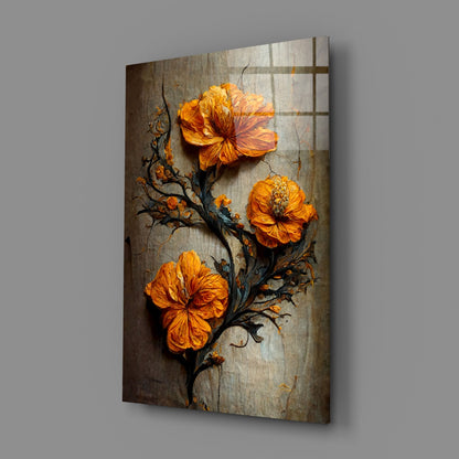 Three vibrant orange flowers with dark branches on weathered gray textured glass panel displayed at an angle.