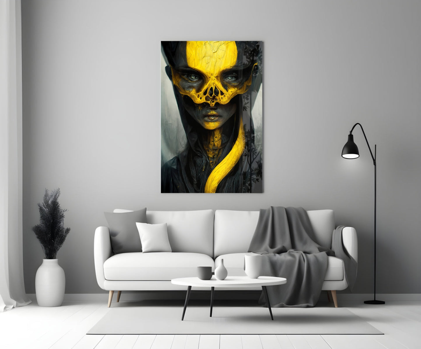 Contemporary art print featuring a stylized portrait with black and gold geometric face design hung above a white sofa in a minimalist living room.