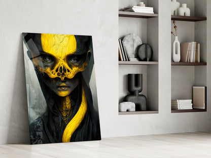 Modern interior room displaying a leaning glass art panel featuring a stylized face with bright yellow skull overlay on black and gray tones, beside white shelving units with decorative objects and books.