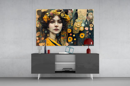 Glass wall art depicting a woman with dark curly hair adorned with yellow flowers and gold circular ornaments against a muted teal and gold background, displayed above a dark console table.