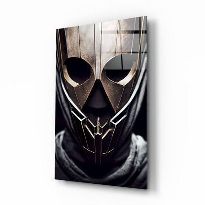 Gold and black metallic mask with angular features and large circular eye openings mounted on dark fabric, displayed as wall art.