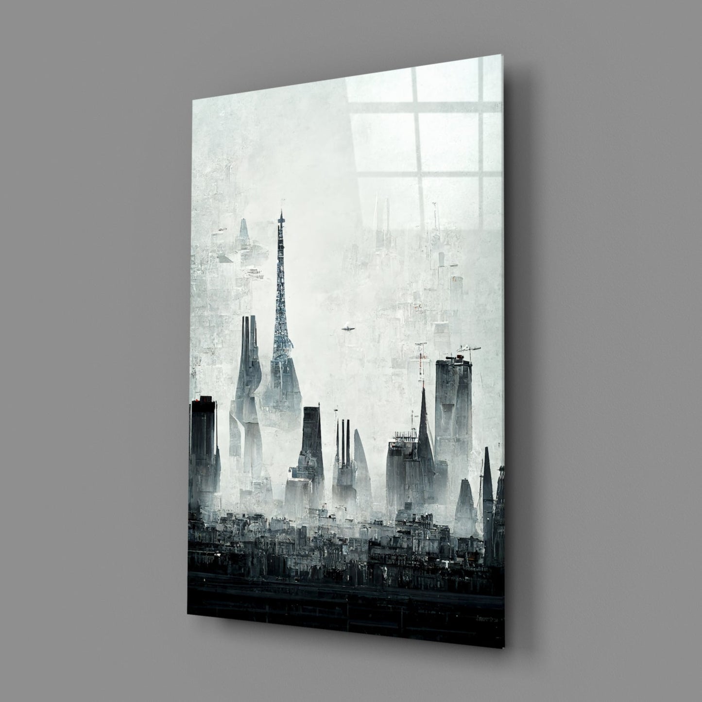 Angled perspective view of black and white cityscape glass art panel mounted on gray wall, showing tall buildings and skyline silhouette.