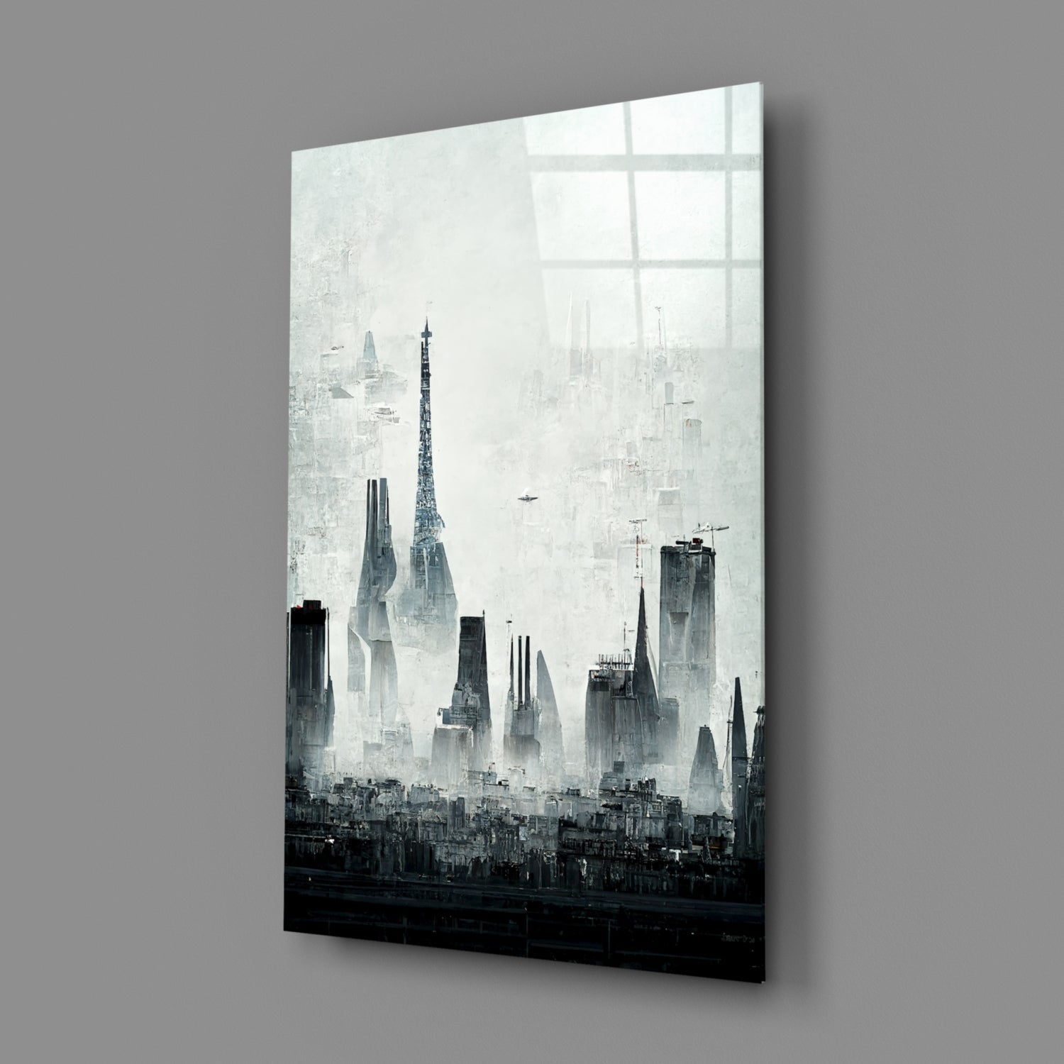 Angled perspective view of black and white cityscape glass art panel mounted on gray wall, showing tall buildings and skyline silhouette.
