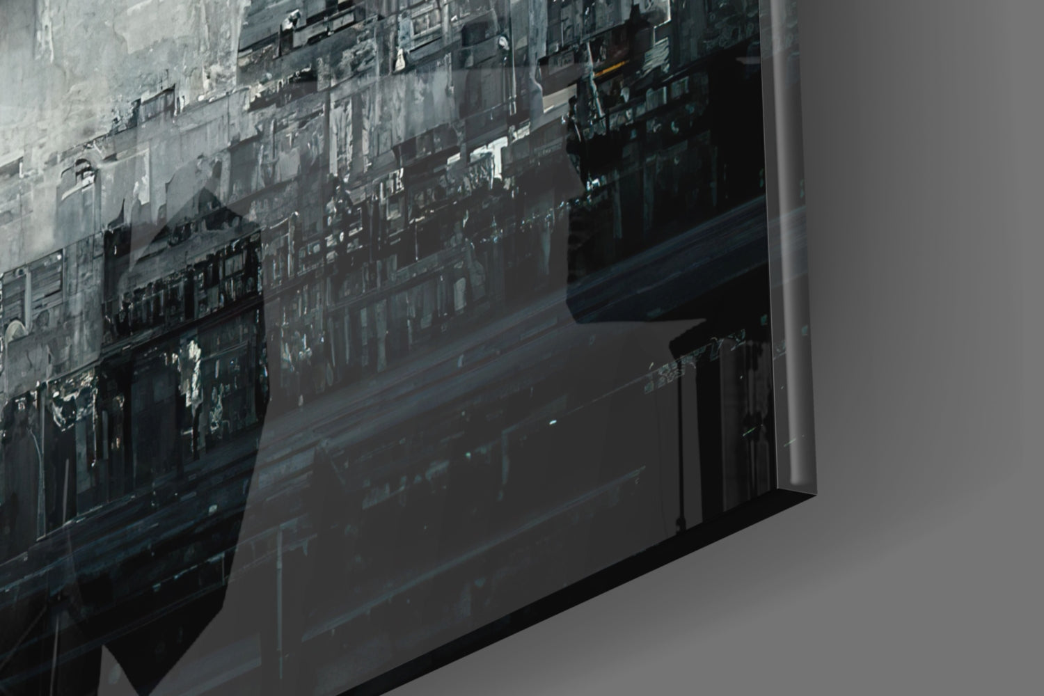 Close-up angled view of frosted glass art panel showing urban cityscape silhouette in grayscale tones.