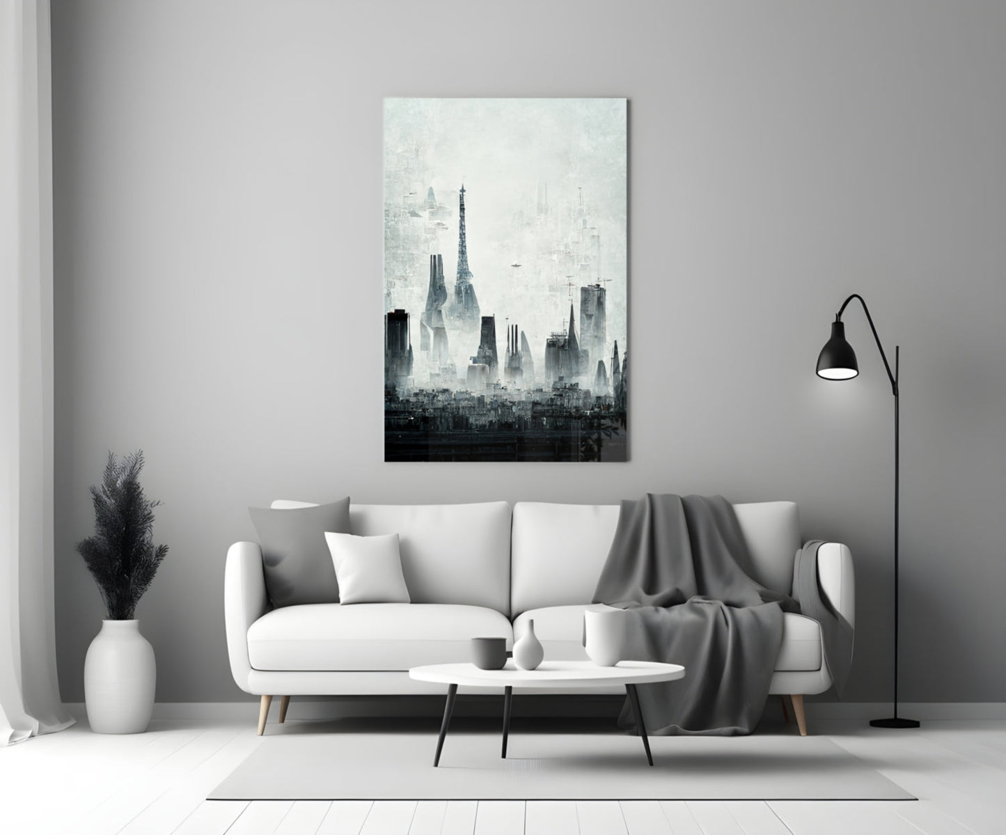 Monochromatic cityscape canvas art depicting layered skyscraper silhouettes hanging above a white sofa in a modern living room.