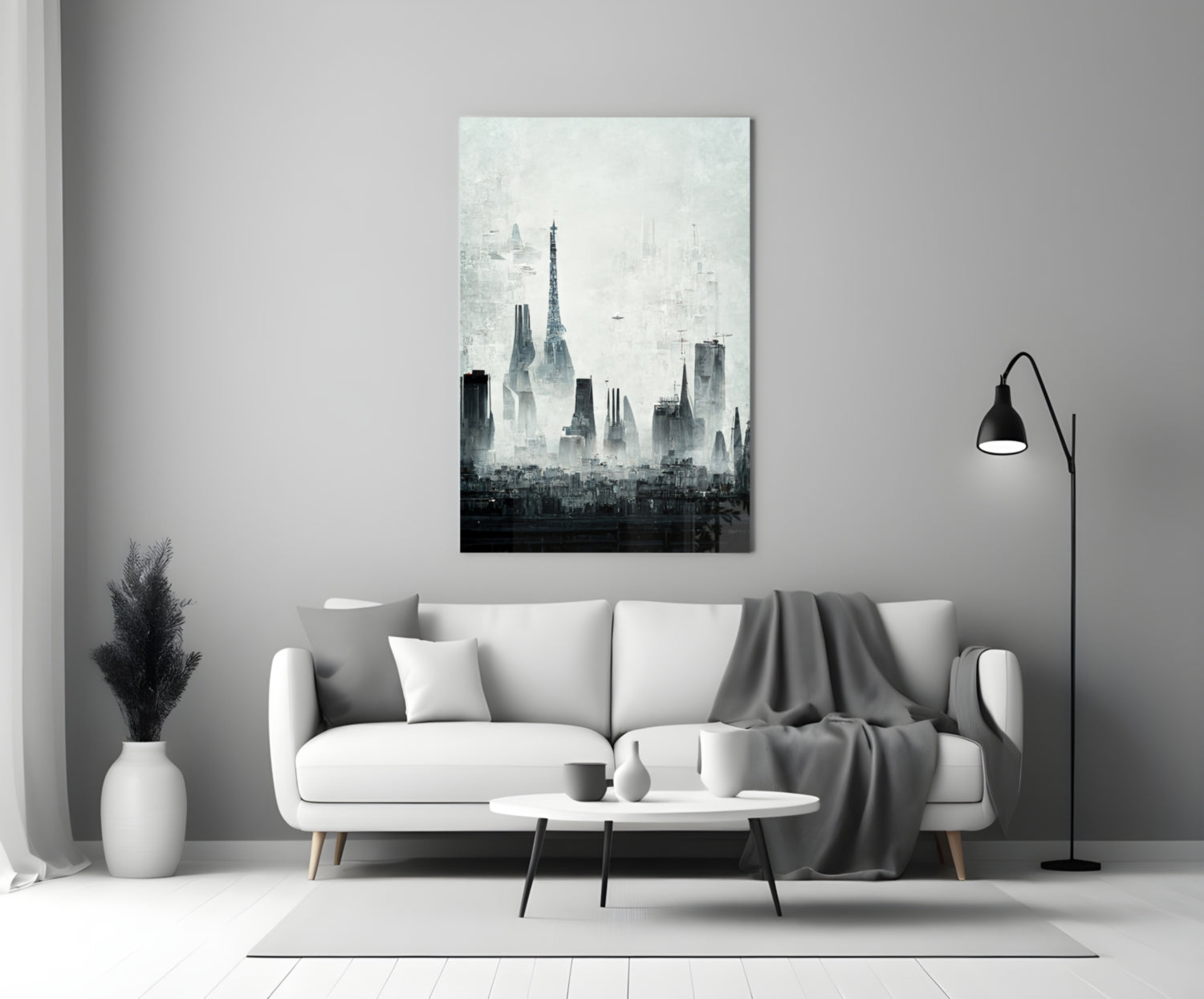 Monochromatic cityscape canvas art depicting layered skyscraper silhouettes hanging above a white sofa in a modern living room.