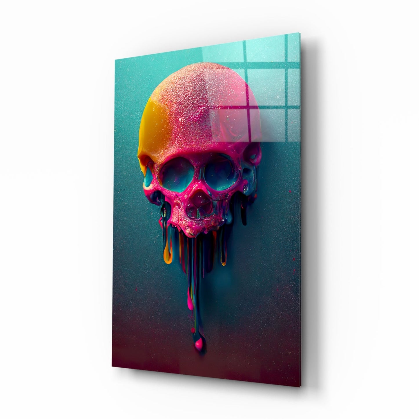 Colorful melting skull with pink, yellow, and orange gradients dripping downward against turquoise and dark teal background with grid pattern overlay, displayed at angle on white surface.