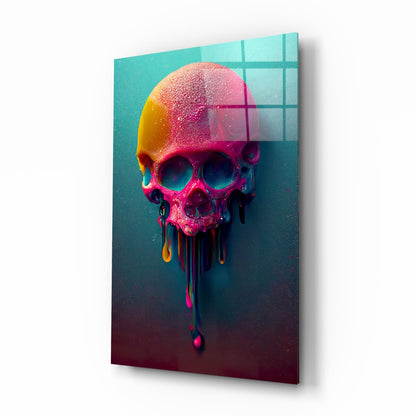 Colorful melting skull with pink, yellow, and orange gradients dripping downward against turquoise and dark teal background with grid pattern overlay, displayed at angle on white surface.