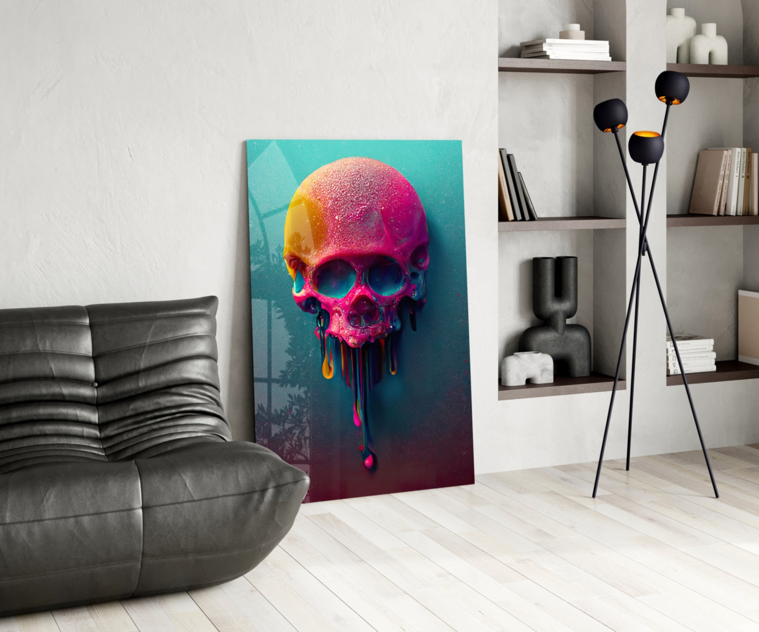 Colorful melting skull glass art displayed in modern living room with gray sofa, black floor lamp, and white shelving unit.