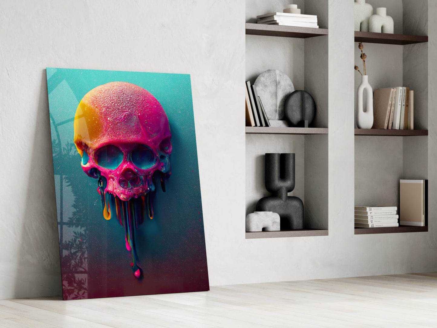 Colorful melting skull canvas leaning against white wall beside built-in shelving with books and decorative objects.