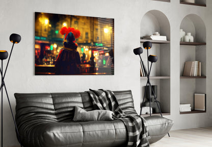 Modern living room interior with black leather sofa displaying framed artwork of figure with red afro in illuminated cityscape.