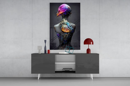 Colorful glass art bust with iridescent purple, gold, and blue bird-head sculpture displayed on modern gray console table with red lamp and decorative objects.