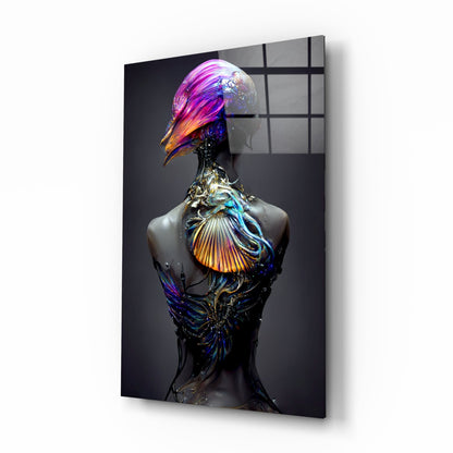 Glass art sculpture of a stylized bird figure with vibrant pink, blue, and gold iridescent glass elements on dark torso against gray background.