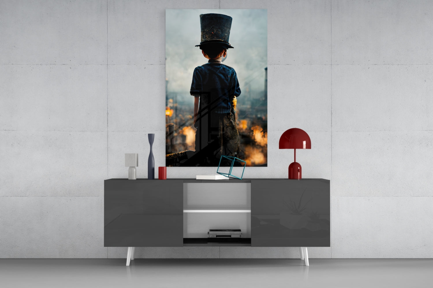 Vertical glass art print displayed on wall above gray console table, showing child in top hat overlooking burning cityscape at golden hour.