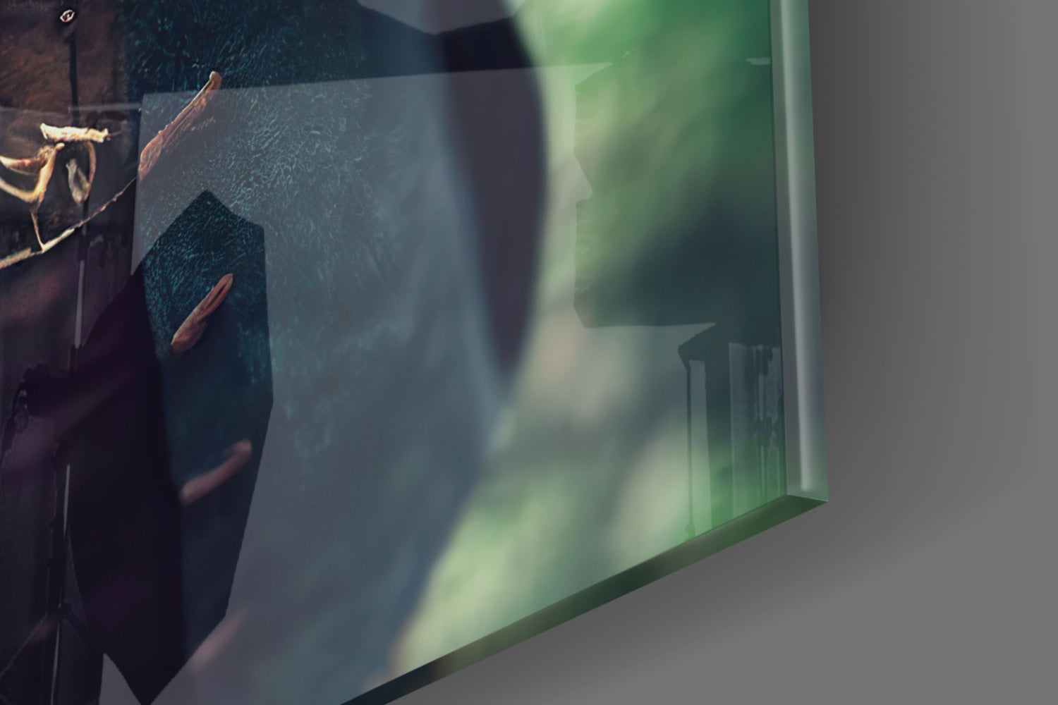 Close-up detail of glass wall art showing textured dark teal surface with brown branch elements and green-tinted glass edge reflection.