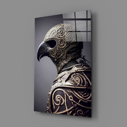 Ornate metal bird skull with intricate filigree detailing displayed on angled glass panel against gray wall.