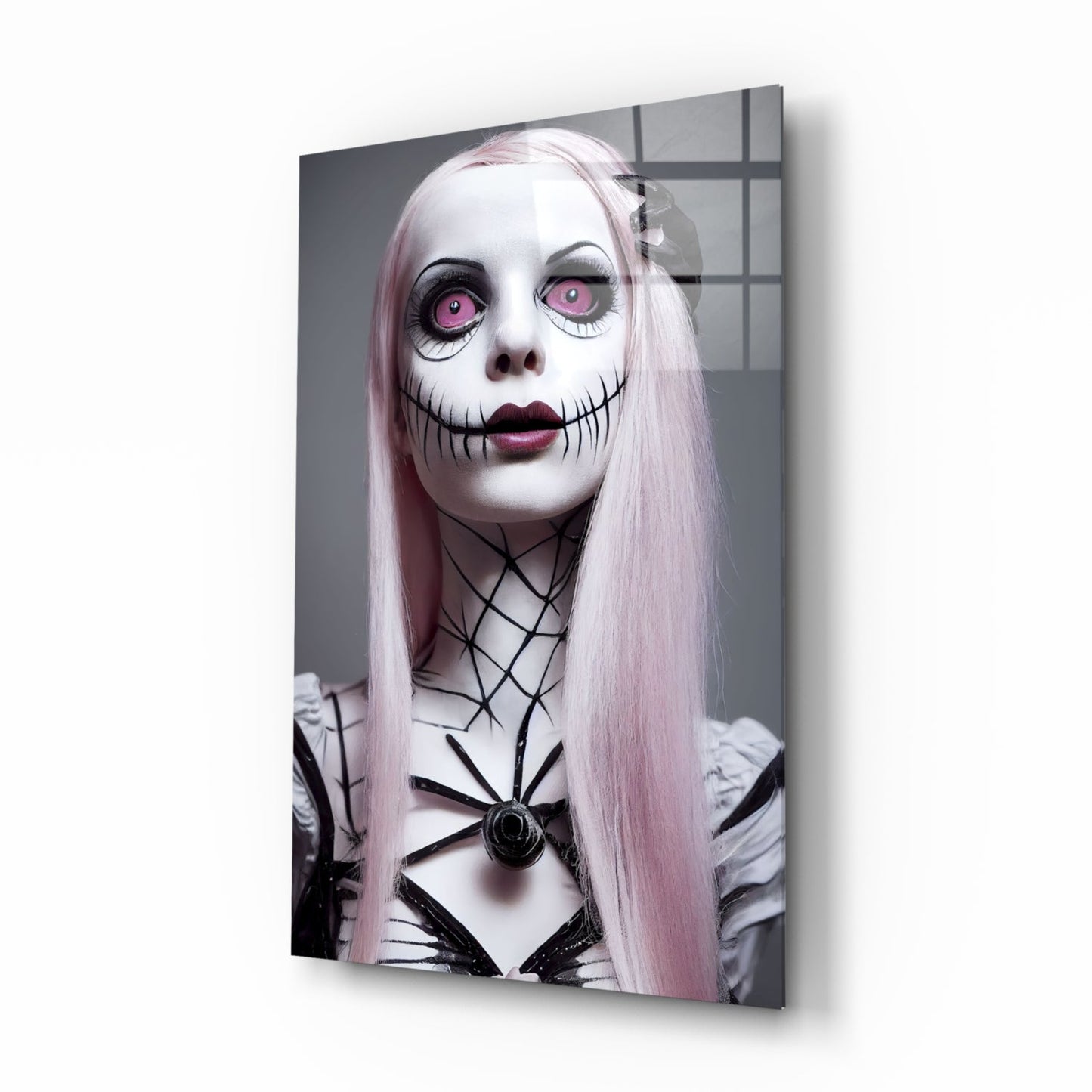 Glass wall art panel showing a pale-skinned figure with long pink hair, pink eyes, black stitched mouth, and spider web chest design against a gridded grey background.