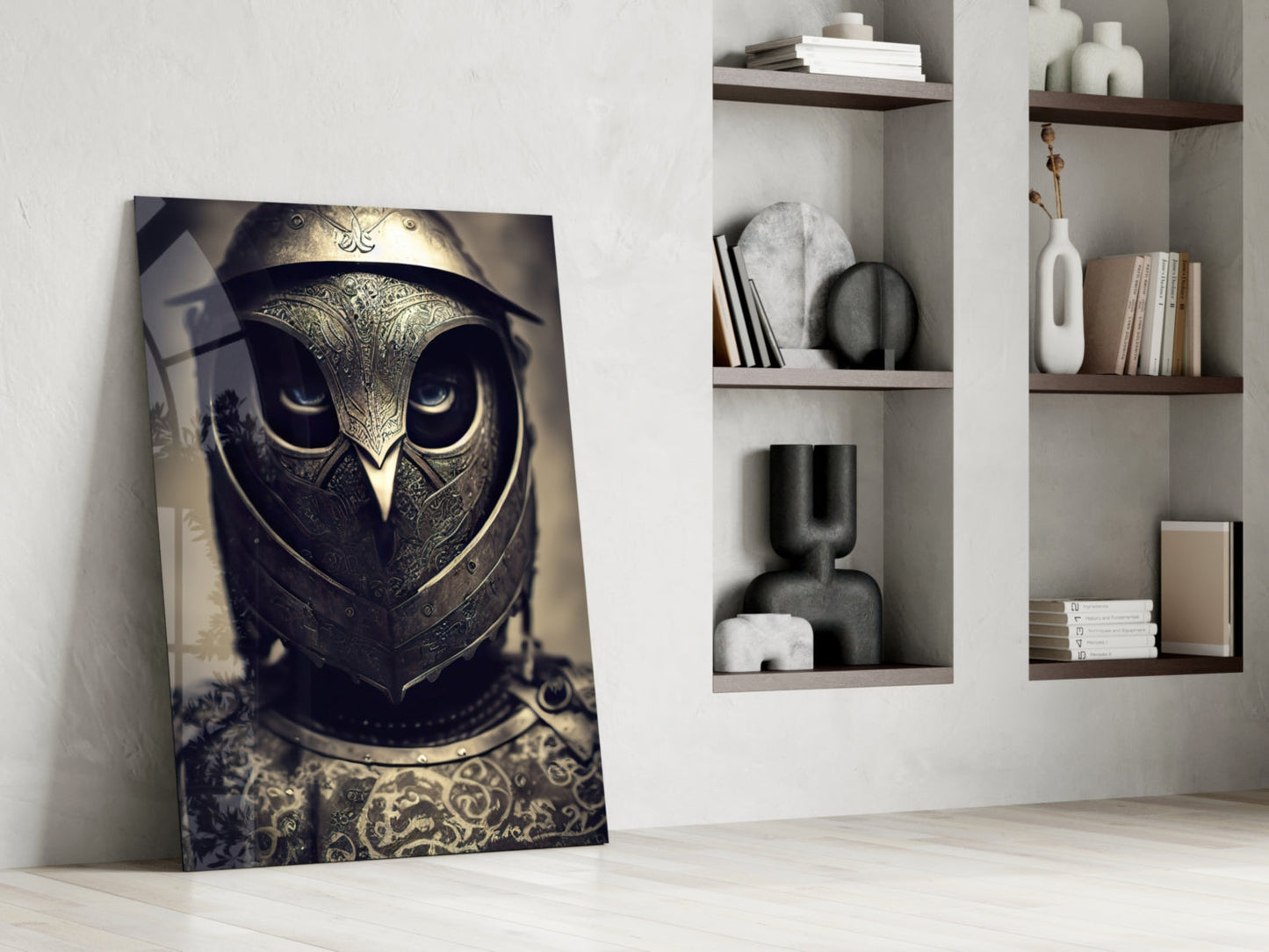 Ornate golden owl helmet artwork leaning against white wall beside minimalist shelving with books and decorative objects.
