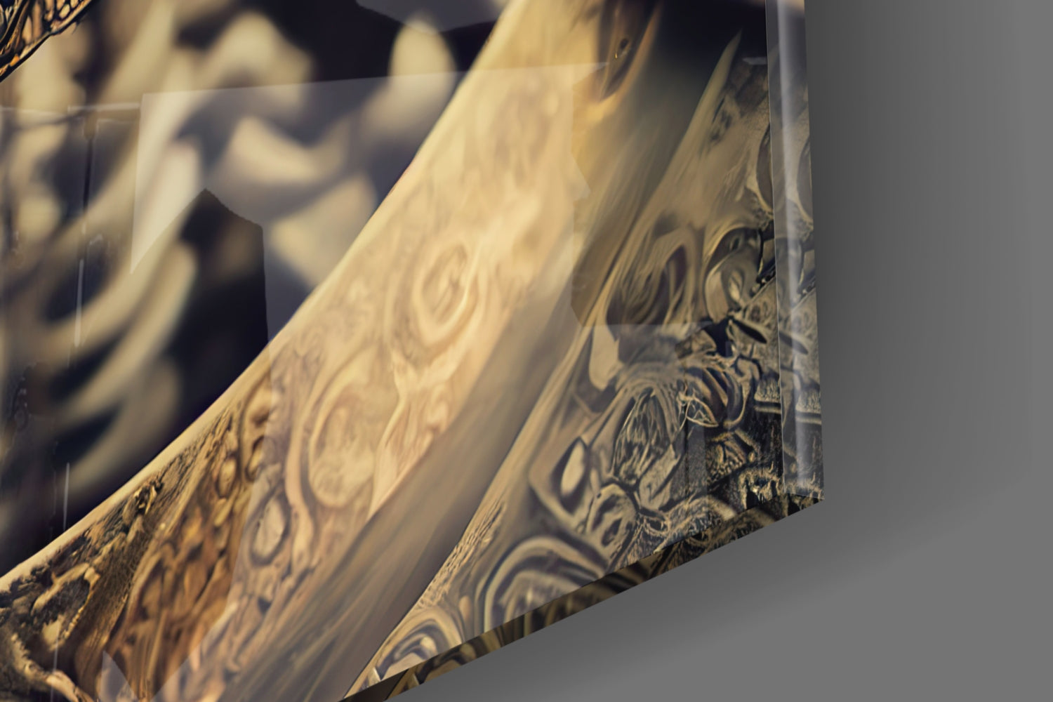 Close-up angled view of etched glass wall art showing ornate decorative patterns and a stylized fighter figure in gold and black tones.