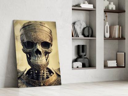 Ornate golden skull artwork leaning against white wall beside shelving unit with decorative objects and books.