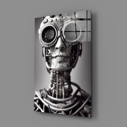 Black and white photograph of a textured skull wearing ornate steampunk goggles, mounted on a vertical glass panel with grid overlay.