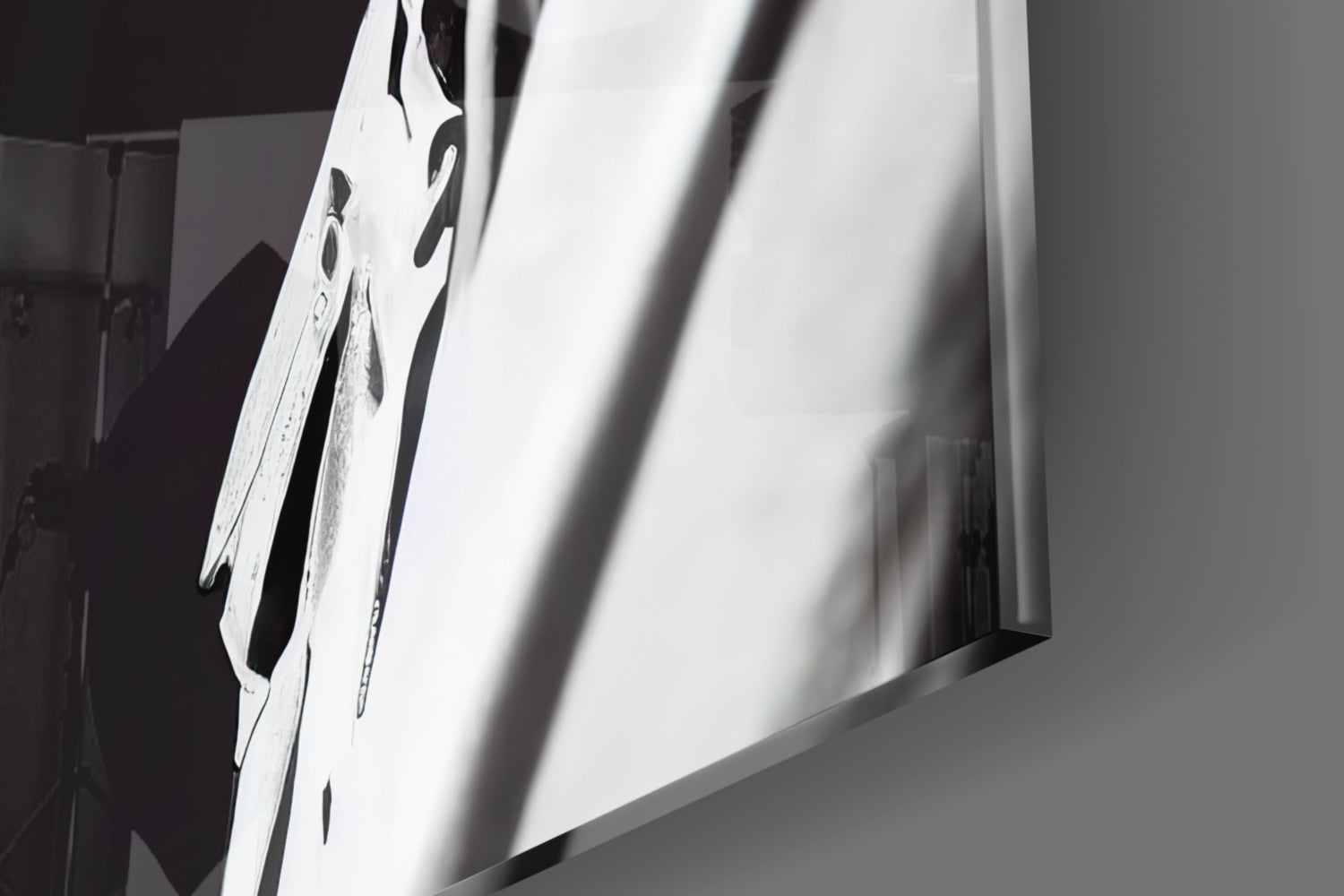 Close-up angled view of white glass art piece with black dragonfly designs and dramatic shadow cast across surface.