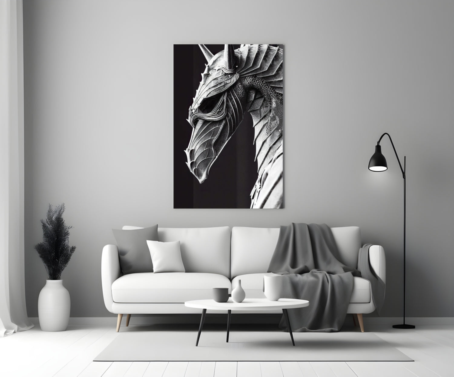 Black and white detailed dragon head artwork displayed above a white sofa in a minimalist living room setting.