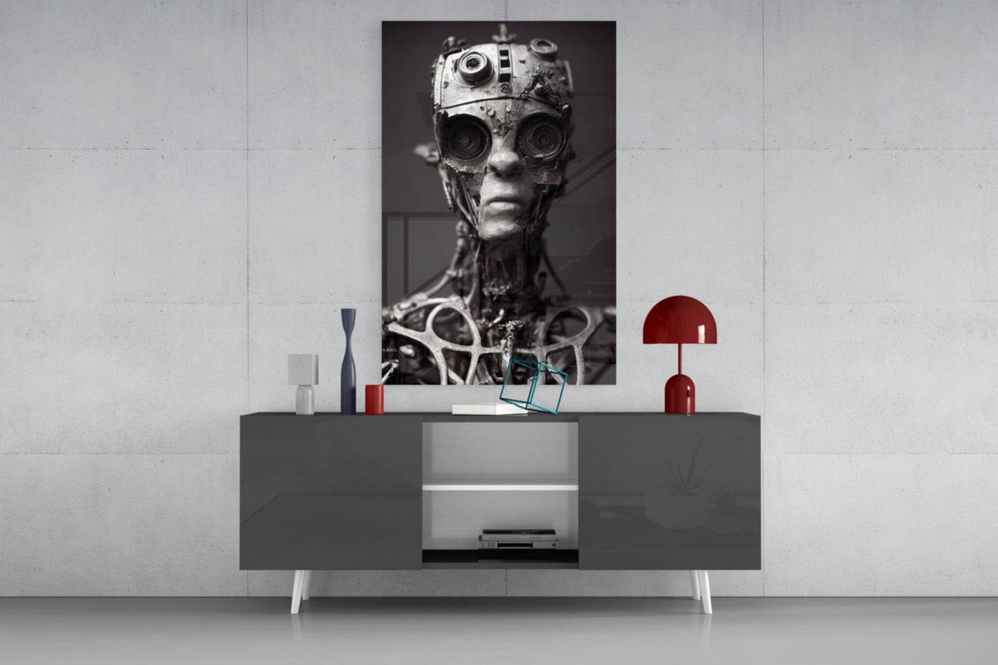 Monochromatic robotic head artwork displayed above gray media console with red decorative lamp and accessories.