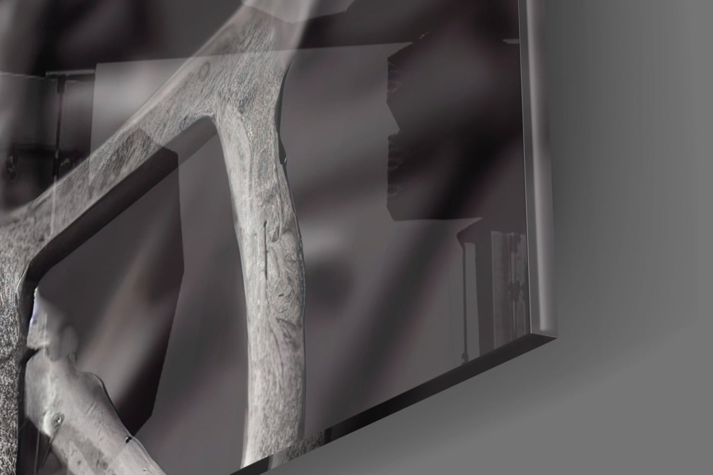 Close-up of weathered wooden frame detail against blurred glass art piece with neutral grey tones.