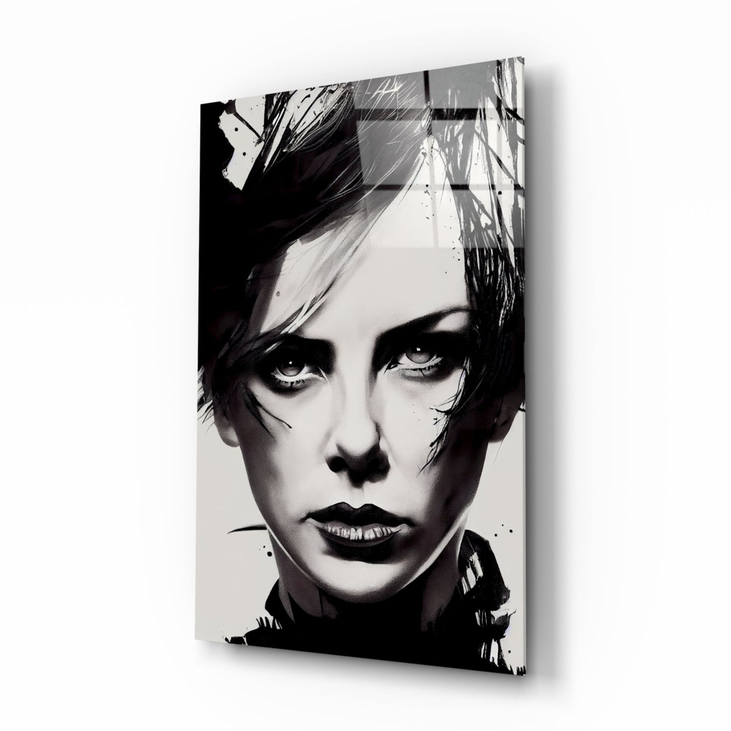 Black and white portrait on glass wall art showing a person with short dark hair and dramatic makeup, displayed at an angle against white background.