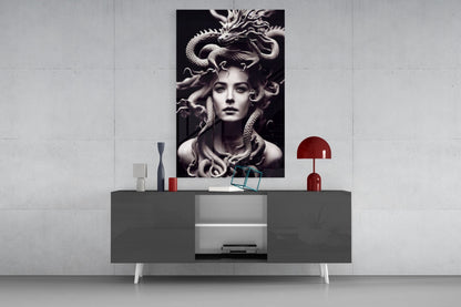 Black and white Medusa portrait artwork displayed above gray media console with red lamp and decorative objects in modern interior setting.