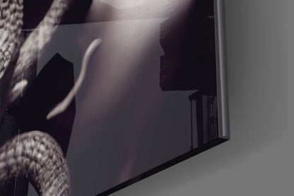 Close-up detail of Medusa glass art showing sculptural profile with translucent white and dark tones against neutral background.
