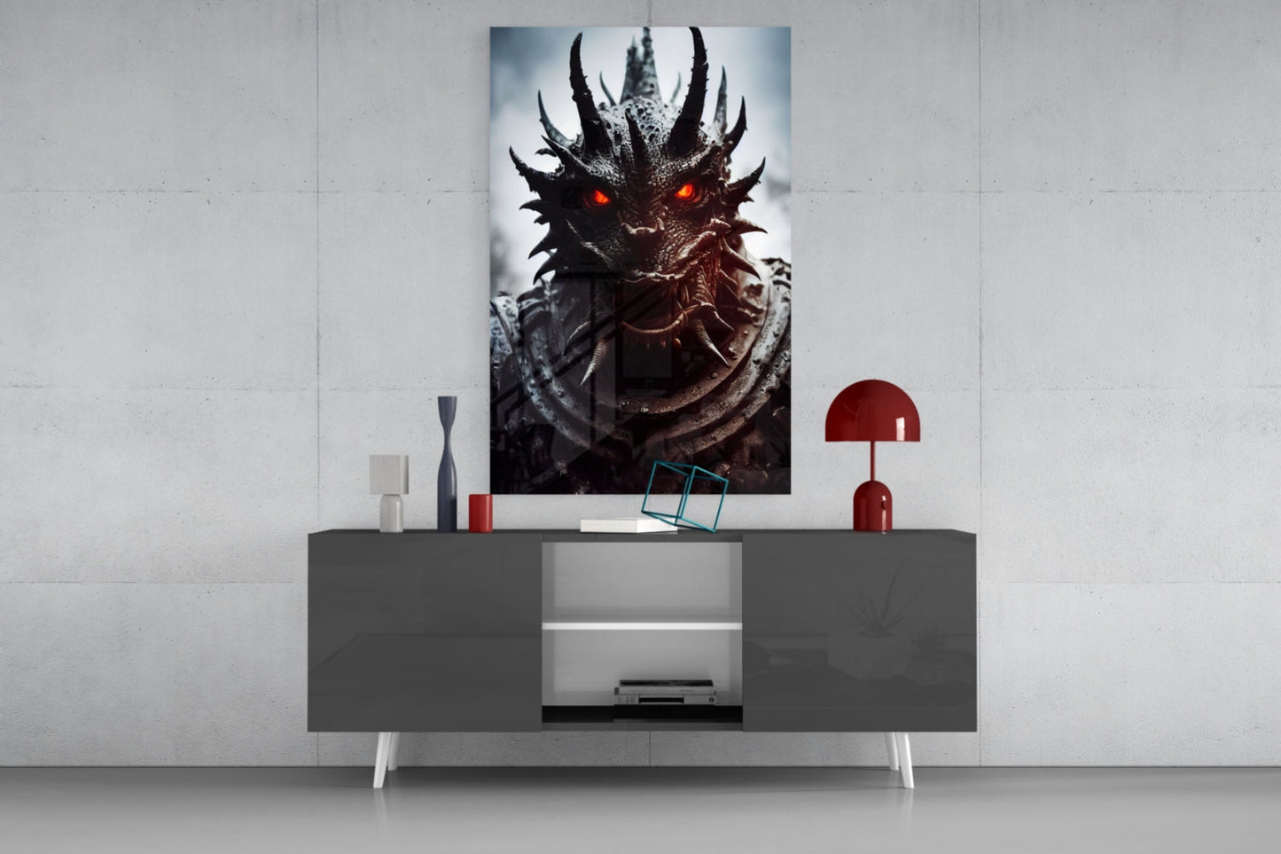The Beast Glass Wall Art displayed on a gray modern sideboard with red decorative accessories and white legs against a light wall.