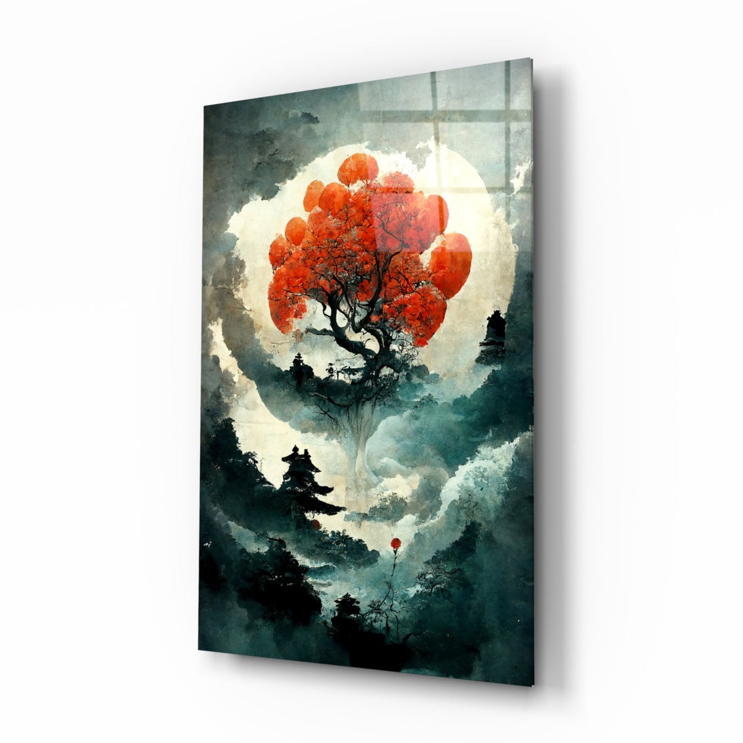 Glass art print displayed at an angle showing a red tree silhouette against a large moon with misty forest landscape below.