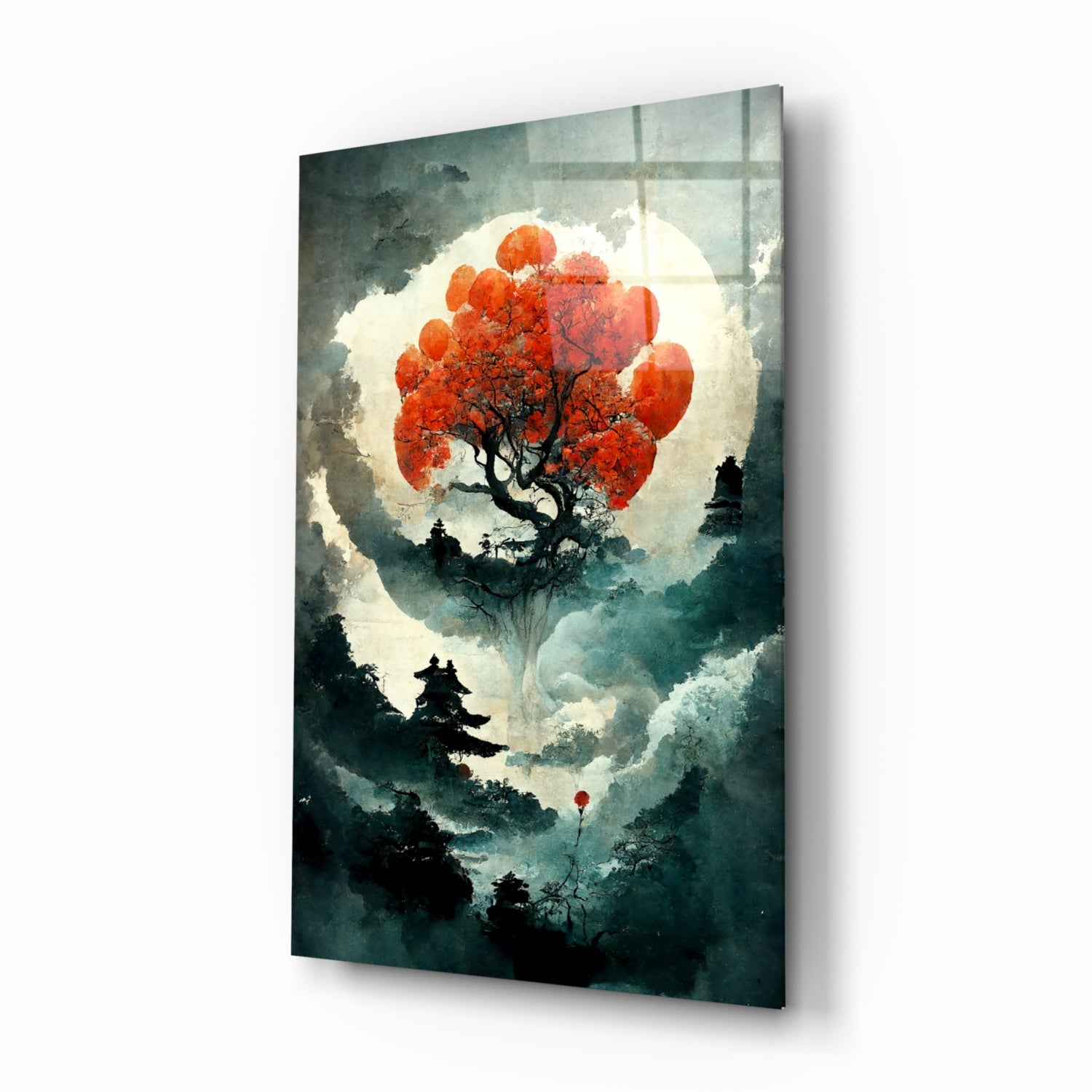Glass art print displayed at an angle showing a red tree silhouette against a large moon with misty forest landscape below.