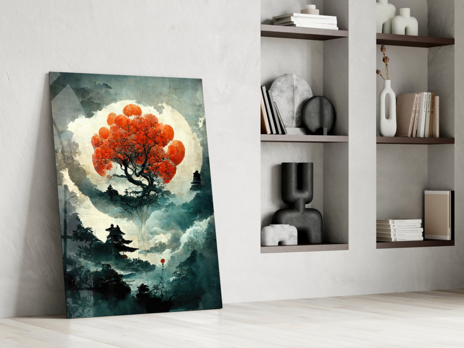 Glass art panel leaning against white wall displays red tree silhouette against luminous moon with teal forest landscape below.