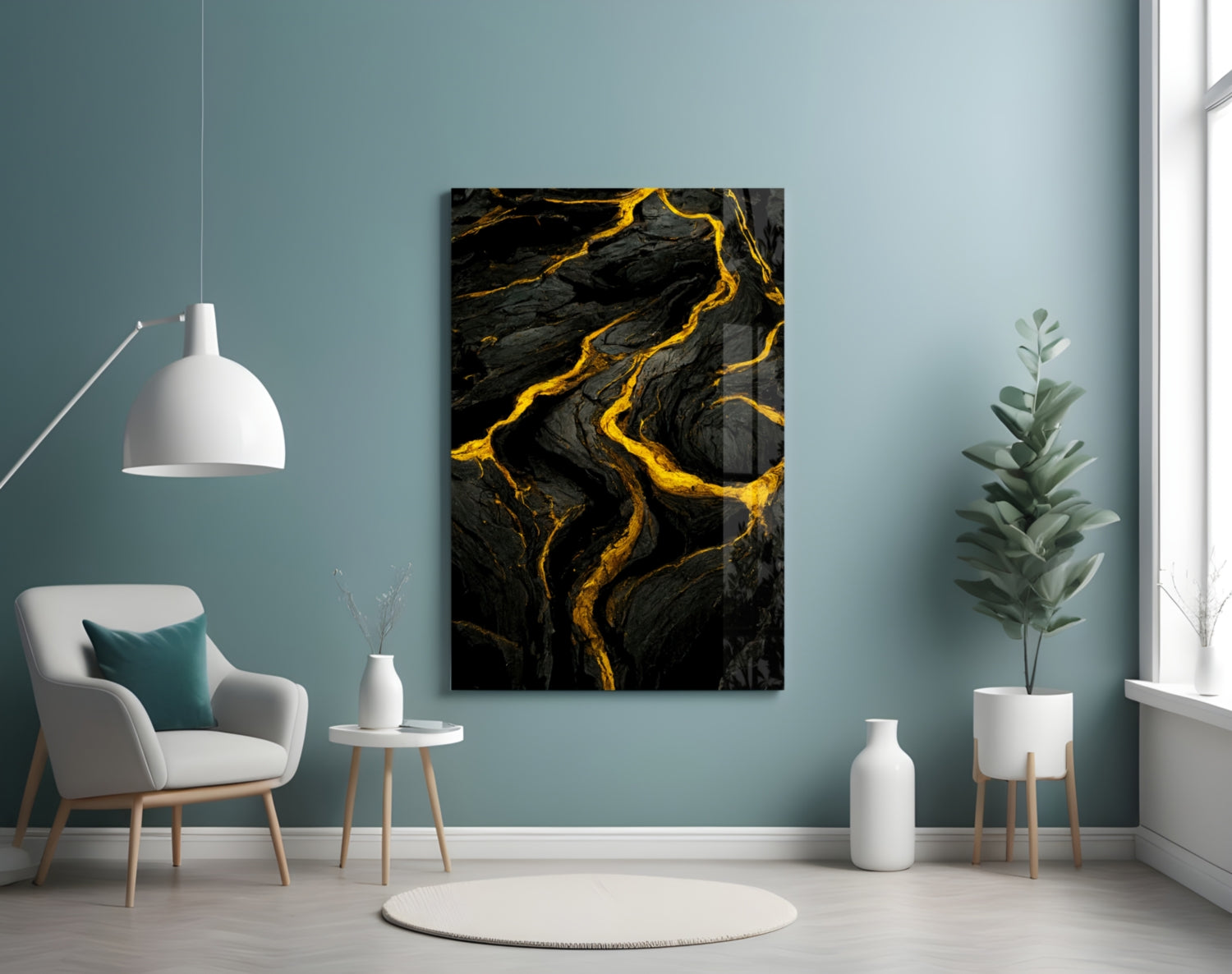 Black and gold marbled slit glass art panel displayed on a teal wall above a white armchair in a modern interior setting.