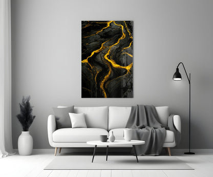 Black and gold marbled slit glass art panel hanging above white sofa in minimalist living room interior.