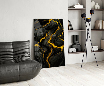 Modern living room interior featuring black and gold marbled glass art leaning against wall beside gray leather chair.