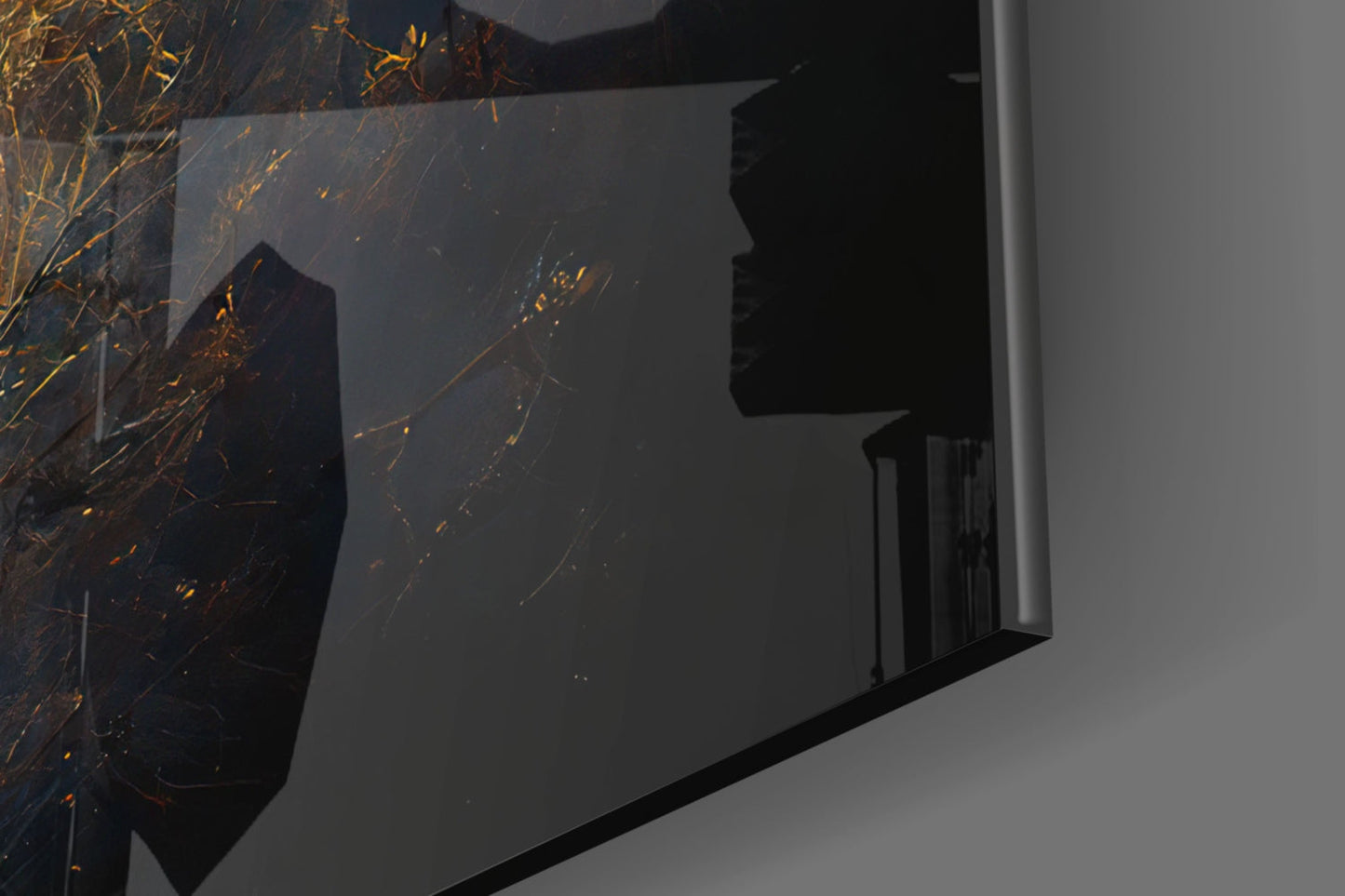 Close-up angled view of black glass wall art with golden branching lines and sparkles against gray wall backdrop.